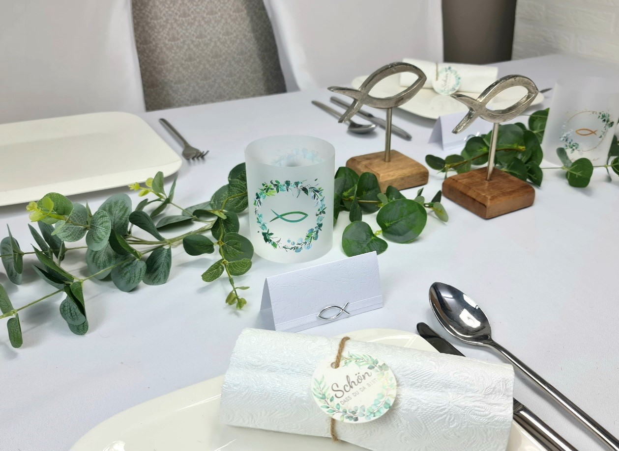 Efeu, Fische auf einem Holzsockel und Lichthüllen sind auf diesem eleganten Tisch die Hauptdarsteller
